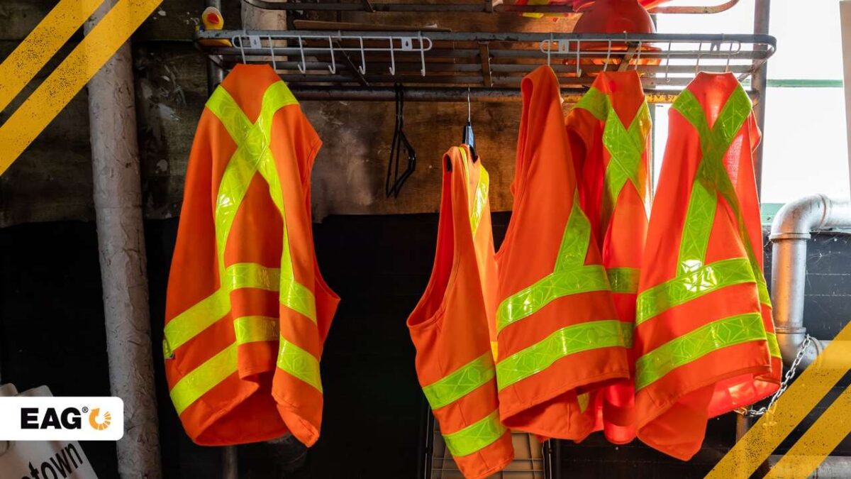 cinco uniformes de proteção pendurados em um local de trabalho com um grande grau de risco